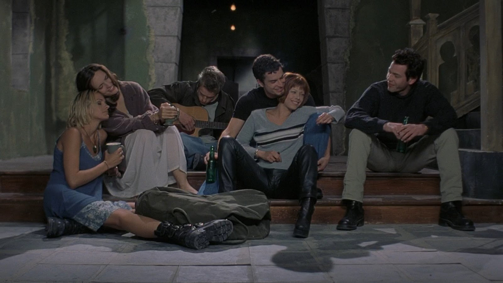 The whole group of teens sitting on a step