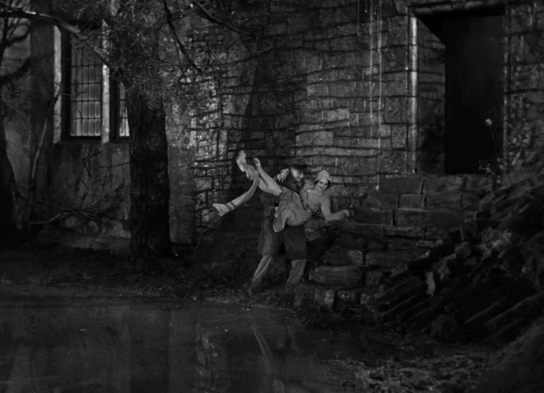 Dude poorly attempting to carry a lady through mud