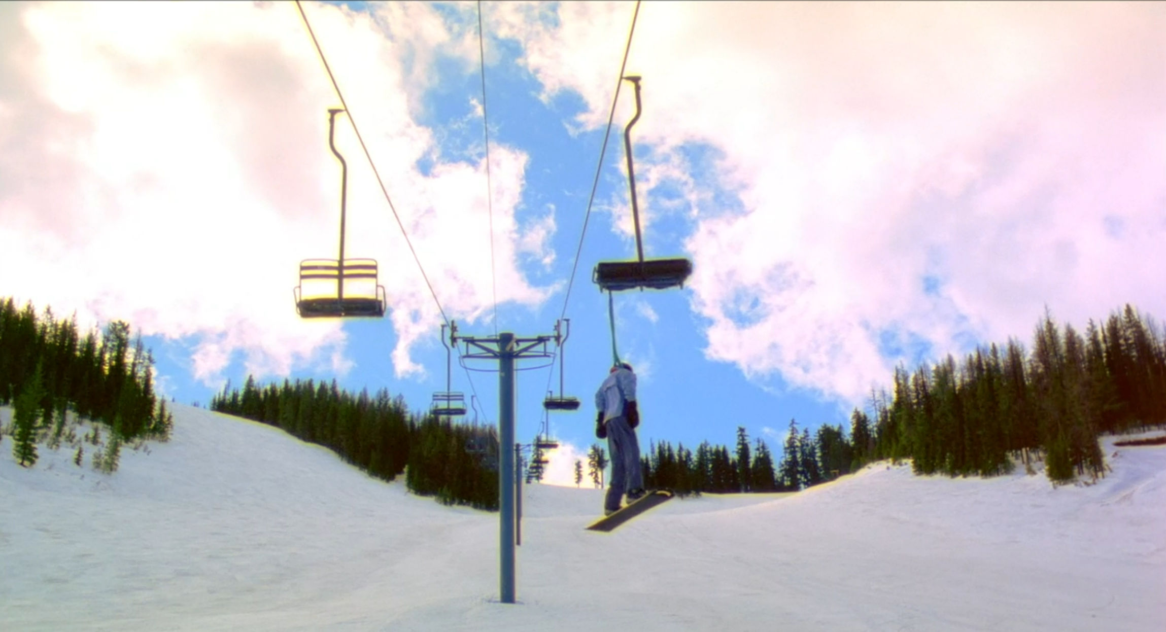 Kimberly dangling from the snow lift