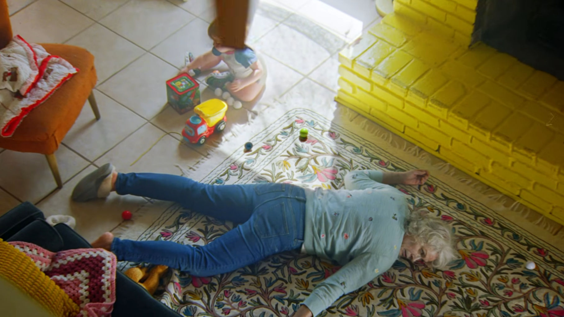 A wider shot of Grandma on the floor