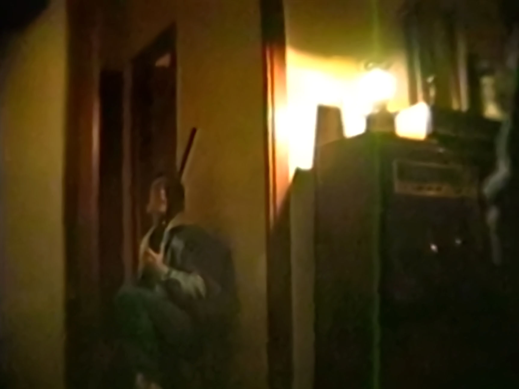 Eric getting ready to shoot an alien that's on the roof.