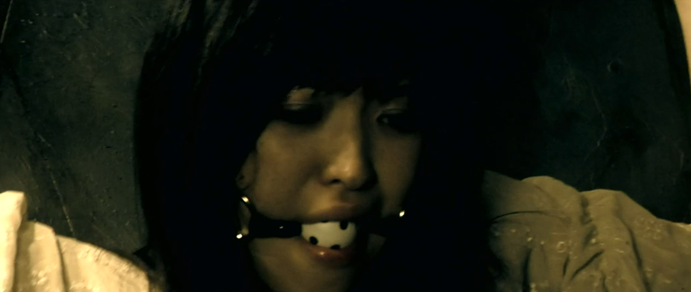 Aki tied up and gagged.