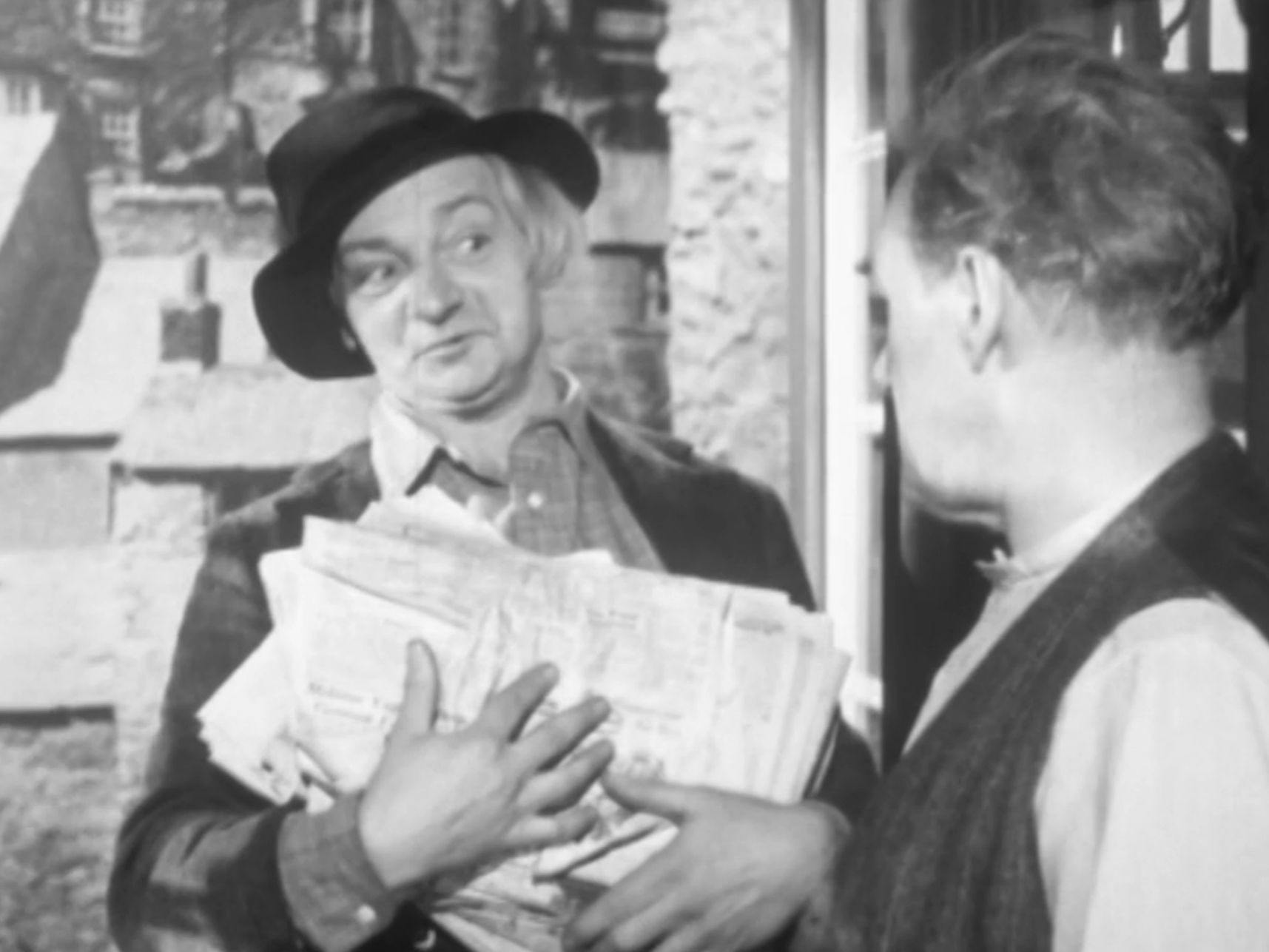 Kelly picking up the newspaper
