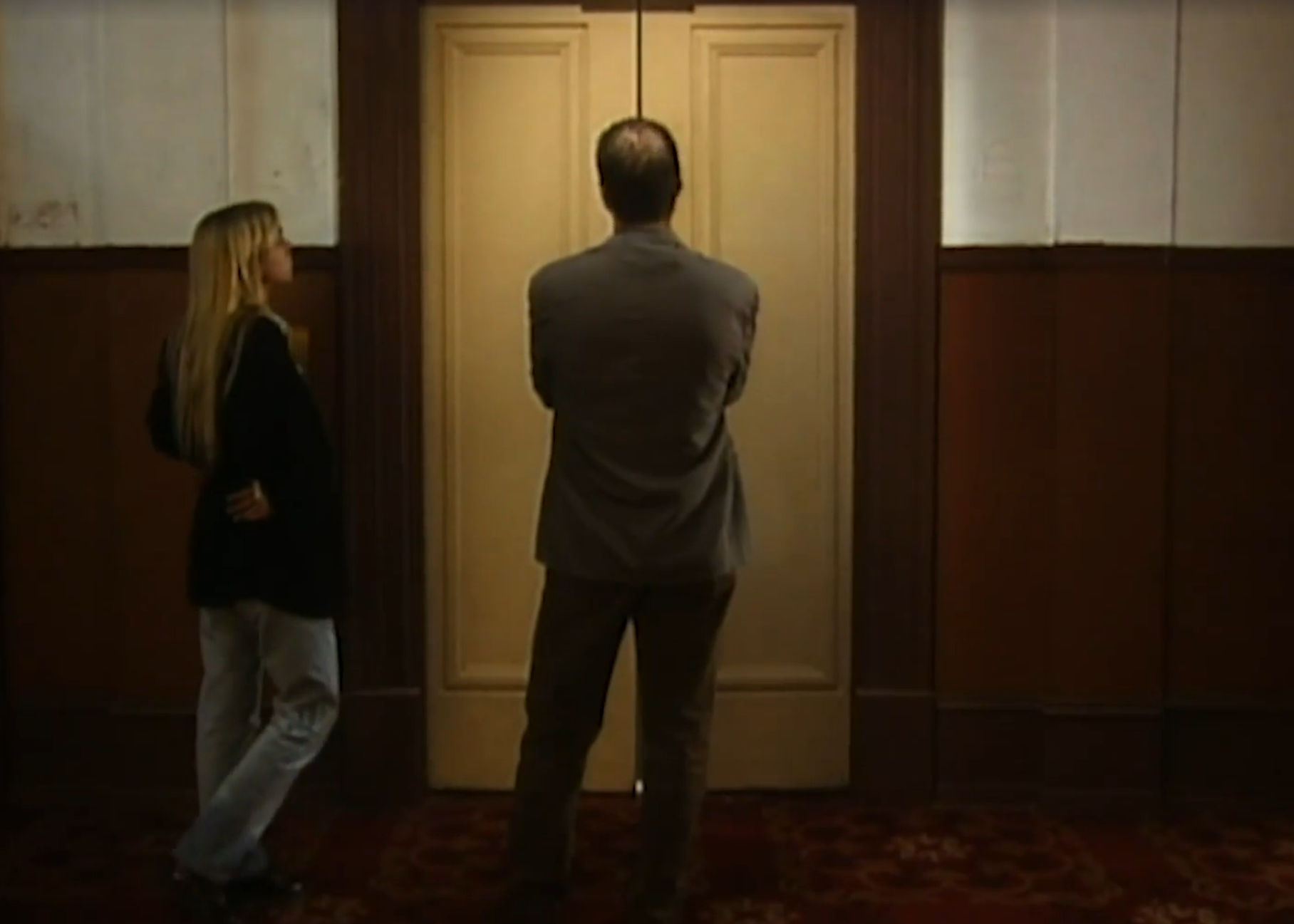Man and woman waiting at elevator