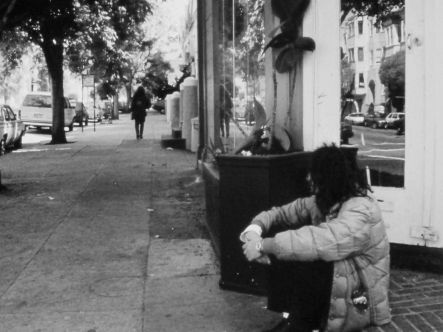 The drug dealer sitting on a curb, rethinking his life