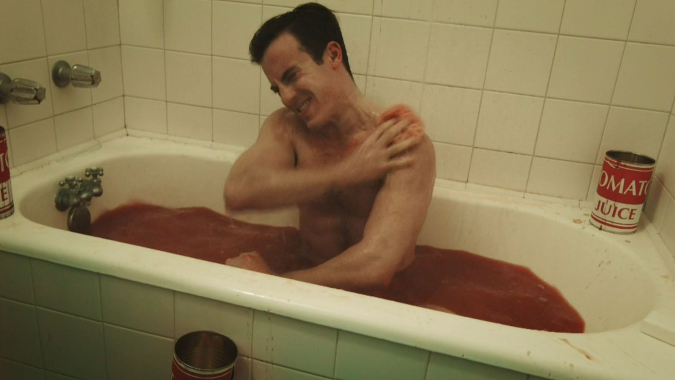 Curtis scrubbing himself with tomato juice
