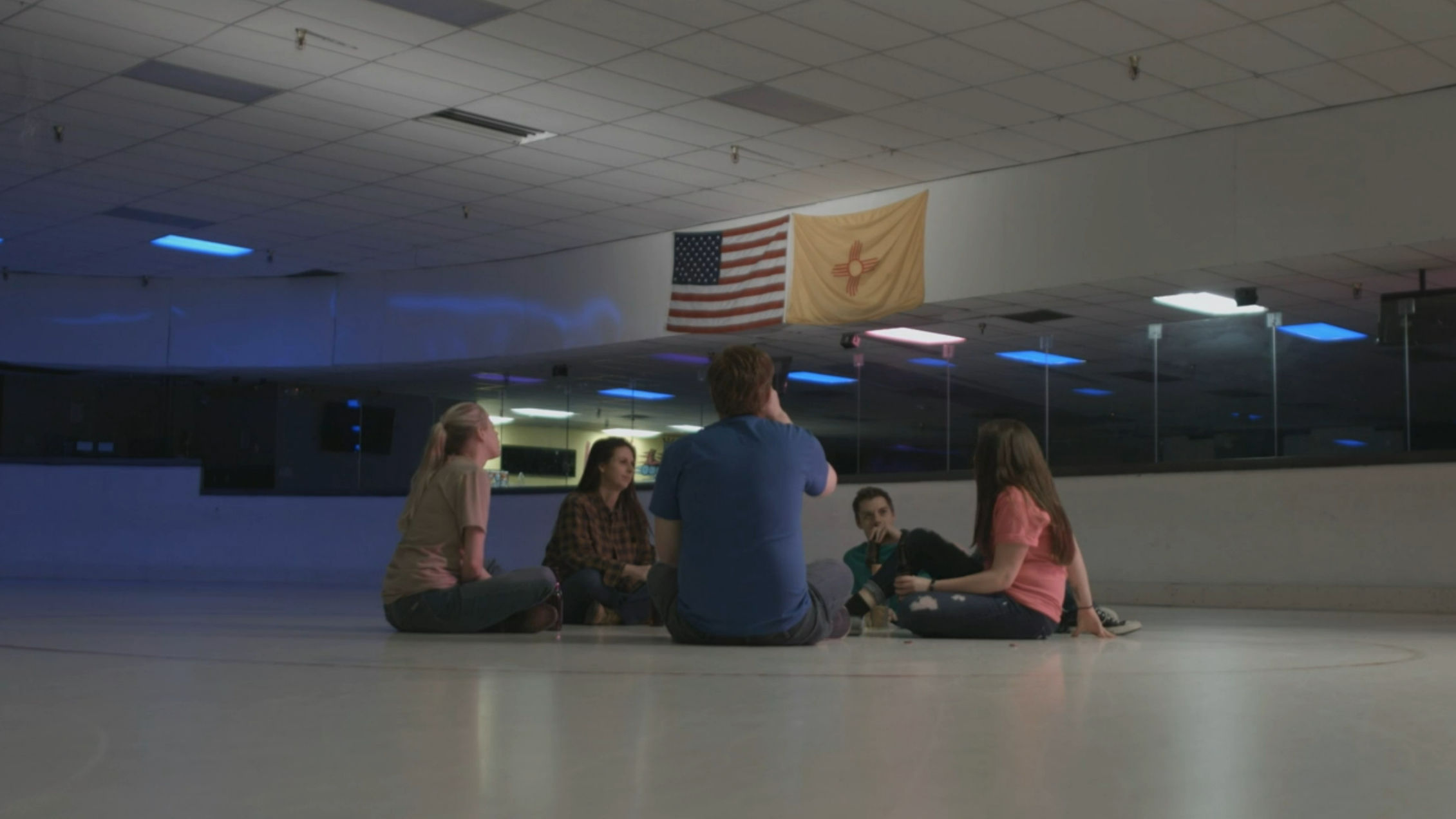 The staff just sittin' around on the roller rink